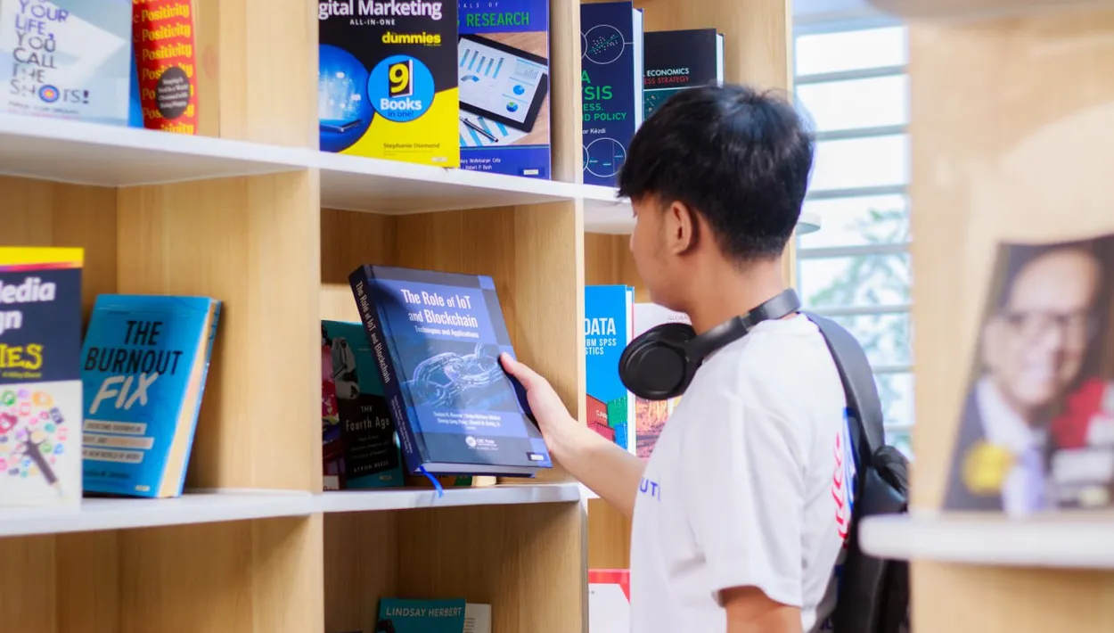 Student searching for a book in a library